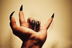 demonic hand showing rock music gesture